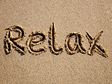 Relax written in sand