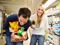 Man and woman holding items at grocery store