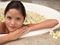 Woman in bath of flower pedals