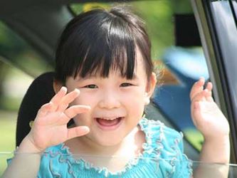 Little Asian girl waving good-bye