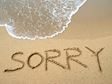 Sorry written on sand on beach