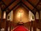 cross at then end of aisle of evangelical protestant church