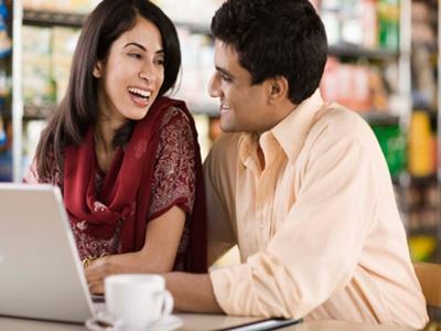 Man and woman looking at a laptop on a date