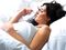 Woman sleeping on white sheets in bed