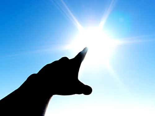 Finger pointing to the sun