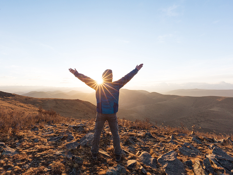 inspiration-man-arms-up-sun-mountains-morning